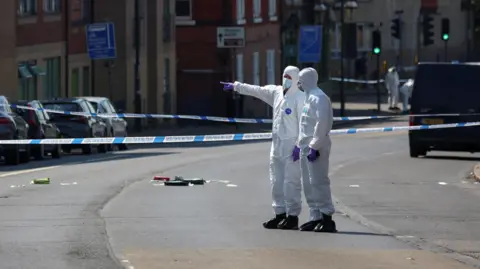 Reuters Forensic officers in a large police cordon in Nottingham's city centre on the 13 June 2023
