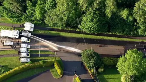 Water cannon spraying towards protestors 