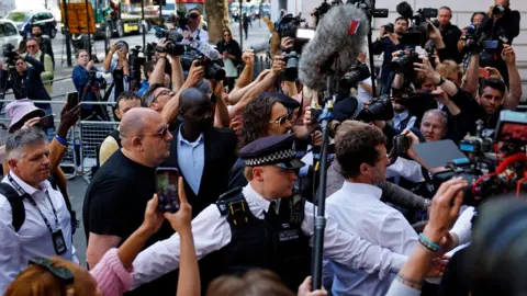 Getty Images Russell Brand arrives at Westminster Magistrates' Court on May 02, 2025 in London, England