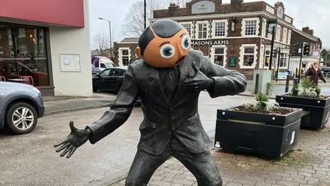 Frank Sidebottom statue on Stockport Street Road in Timperley, Greater Manchester.