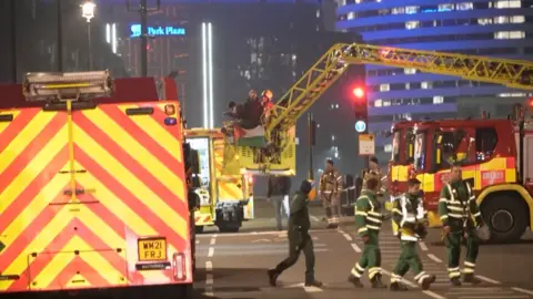 Emergency crews lower to the ground a protestor who had climbed Big Ben.