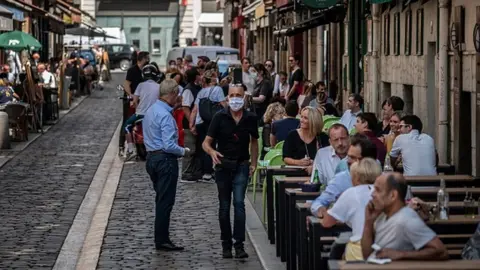 Getty Images People eat in a restaurant in Lyon in June
