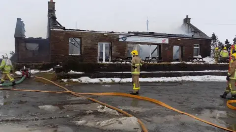 CUMBRIA FIRE AND RESCUE SERVICE Firefighters at the scene of the blaze in 2018