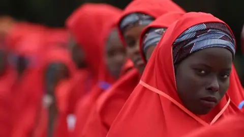Brides wearing red hijabs from the 2023 Kano mass wedding in Nigeria