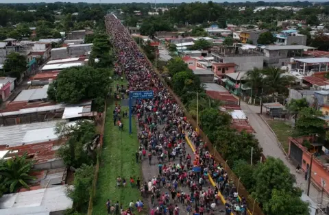 AFP/Getty Images An aerial view of a road filled with migrants stretching back into the distance