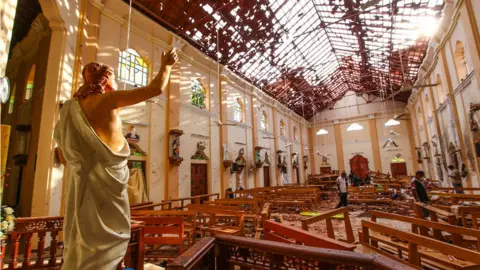 Anadolu Agency/Getty Images A statue of Jesus with his arm raised amid debris at St Sebastian's Church in Negombo, Sri Lanka following the Easter Sunday Bombing