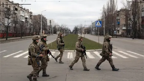 Getty Images Servicemen of Ukrainian Military Forces walk in the small town of Severodonetsk, Lugansk Oblast, on February 27, 2022.