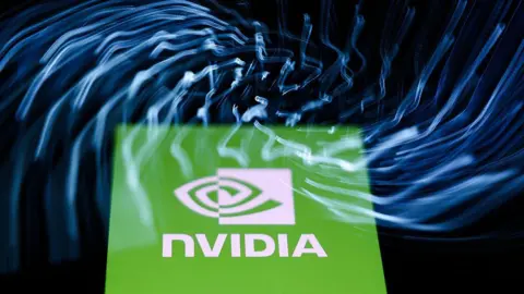 A laptop keyboard and Nvidia logo displayed on a phone screen are seen in this multiple exposure illustration photo 