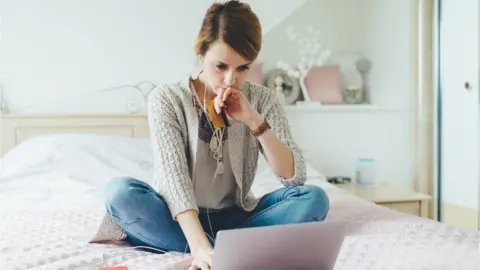 Getty Images Woman shopping online