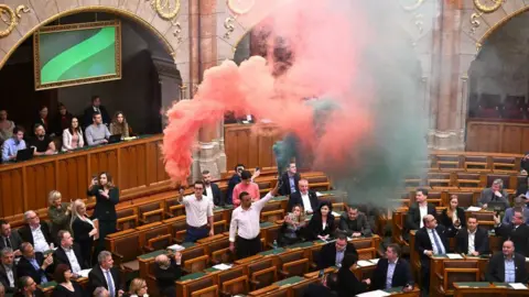 Getty Images Opposition Lawmakers ignite flares in Parliament in protest against vote