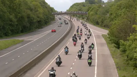 A procession of motorbikes on a motorway