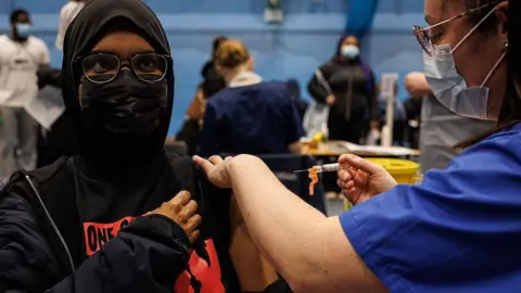 Getty Images A student receives the Meningitis B vaccine at the University of Kent sports hall