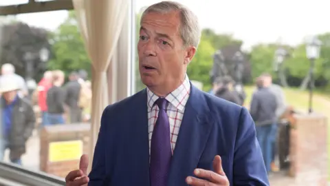 PA Nigel Farage speaking to the media during a visit to Wyldecrest Sports Country Club in Corringham, Essex