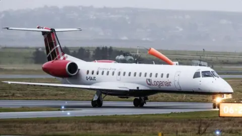 Loganair A small plane taking off in cloudy conditions