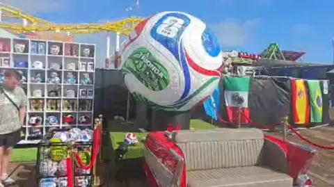 Supplied An oversized football next to flags and World Cup merchandise at a box park