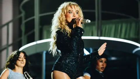 Primavera Sound Sabrina Carpenter singing in a short black sequined dress