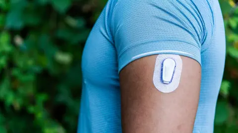 Getty Images Athlete wearing a CGM