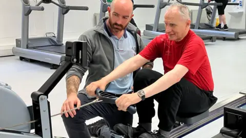 BBC Patient using a rowing machine at the 'prehabilitation' gym