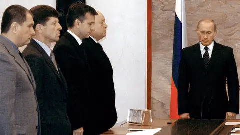 AFP/Getty Putin and cabinet members observe a minute of silence in 2004 after the Beslan school siege