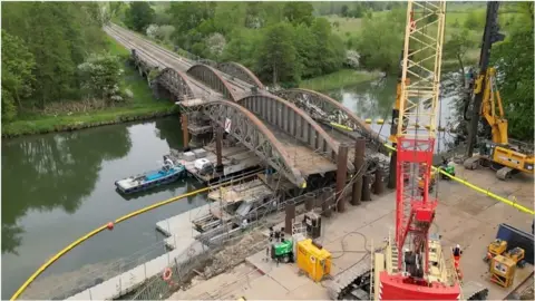 Viaduct over river being repaired with crane