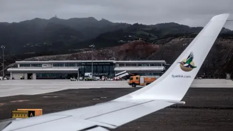 AFP As seen from inside the cabin, the first ever commercial flight lands at St Helena Airport
