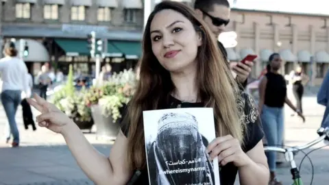 Sahar Samet Sahar Samet holding a poster promoting the WhereIsMyName? campaign