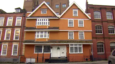 Partou King Street nursery a painted townhouse with white-framed windows, flanked by red-brick buildings on a city street.
