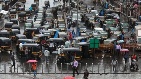 EPA A general view of traffic during heavy rains in Mira road, near Mumbai, India, 01 July 2019.