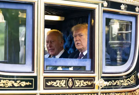 Samir Hussein/WireImage  King Charles III and U.S. President Donald Trump in a carriage during the carriage procession during the State visit by the President of the United States of America at Windsor Castle on September 17, 2025 in Windsor, England. 