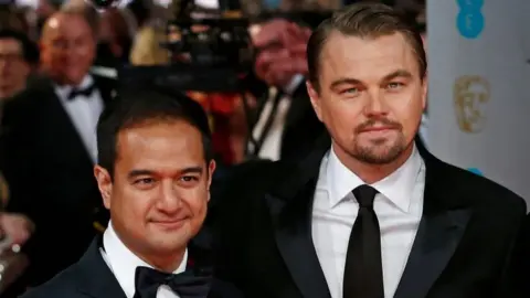 AFP Riza Aziz, left, with Leonardo DiCaprio at the 2014 BAFTA Awards