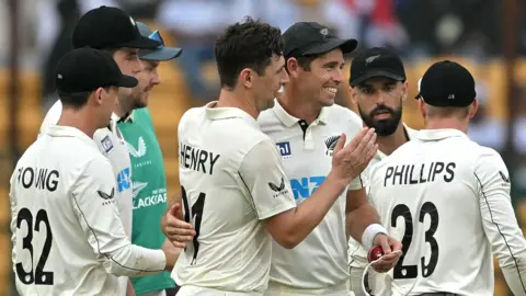 Matt Henry and Tim Southee of New Zealand celebrate a wicket against India