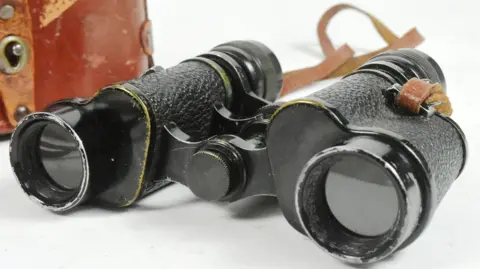 Auctioneum Ltd Sir Barnes Wallis's binoculars on display.