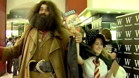 Hagred and Harmiony lookalikes hold aloft the new Harry Potter book at a branch of Waterstone's Book shop