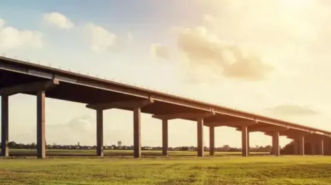 A picture, taken in hazy sunshine, of the M62 Ouse Bridge. Green fields are visible.