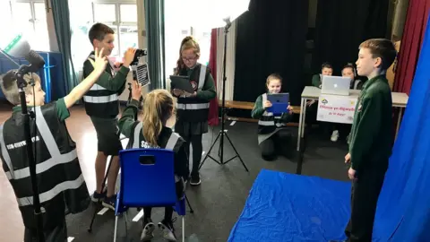 Ysgol y Wern Children producing a weather bulletin