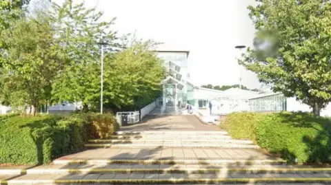 Steps lead up to the entrance of glass fronted building - Spectrum Leisure Centre