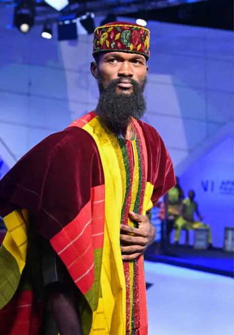ISSOUF SANOGO/AFP A model presents a creation by Gambian designer Ismaila Jallow.