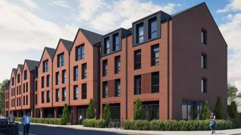 Four-storey brown brick flat development with large dark windows. There are about 10 blocks. They are surrounded by green hedges