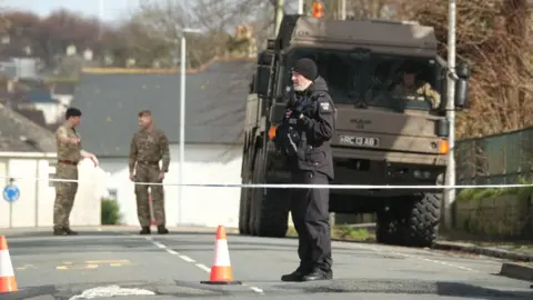 PA Media Police and bomb disposal experts at the scene near St Michael Avenue.