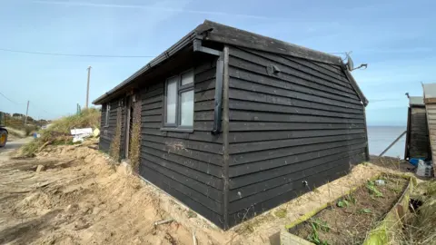 Shaun Whitmore/BBC Lance Martin's house on the cliff edge at Hemsby