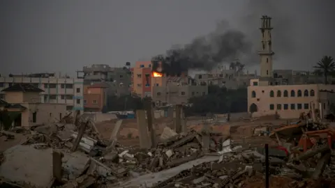 EPA Smoke rises following an Israeli strike on a building in Bureij refugee camp, in the central Gaza Strip in April 2024