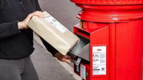 Royal Mail A Royal Mail postbox showing the drop-down metal drawer and a barcode scanner beneath it.