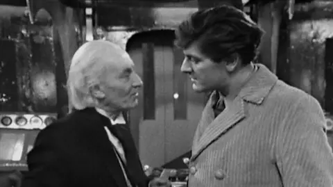 Doctor Who/BBC The two actors on board a spaceship in a scene from a black and white episode