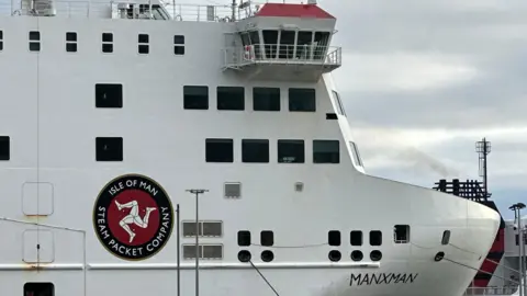 The front of the Manxman ferry, which is white and has the Steam Packet's logo on the side.