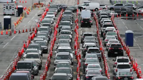Getty Images Long line of cars at a testing site in Miami