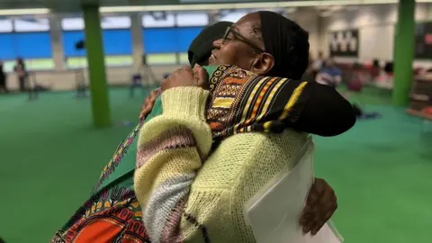 Pete Simson/BBC Two women hug each other at the local election count in Brislington Bristol as the Green Party took control of the city council