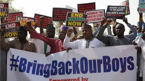 AFP Supporters of the "Coalition of Northern Groups" (CNG) rally to urge authorities to rescue hundreds of abducted schoolboys, in northwestern state of Katsina, Nigeria on December 17, 2020 -