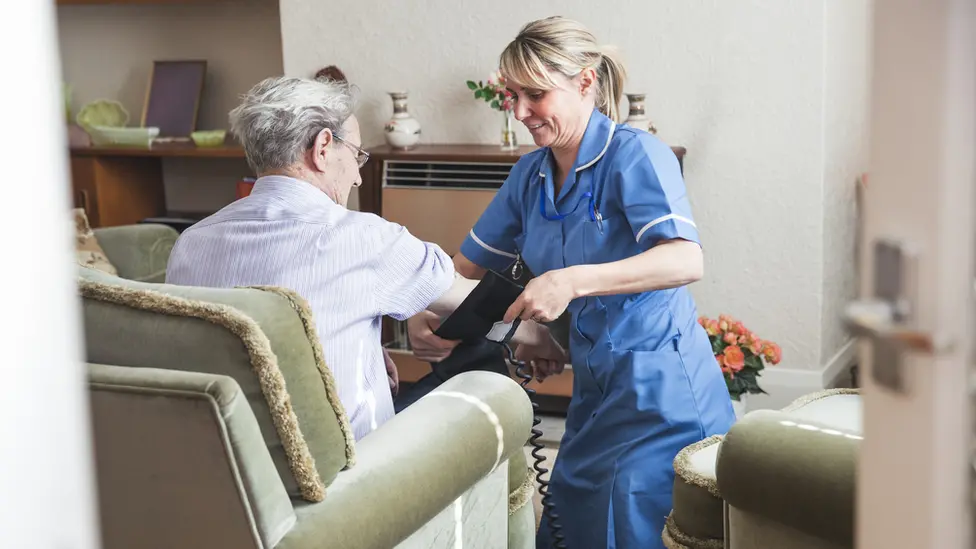 Getty Images A woman with a social care worker