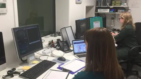 Medical researchers sit at their desks