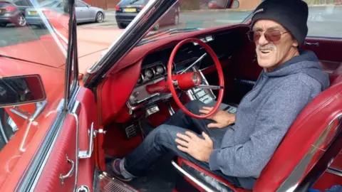 Supplied David Jenkins sitting in a red car